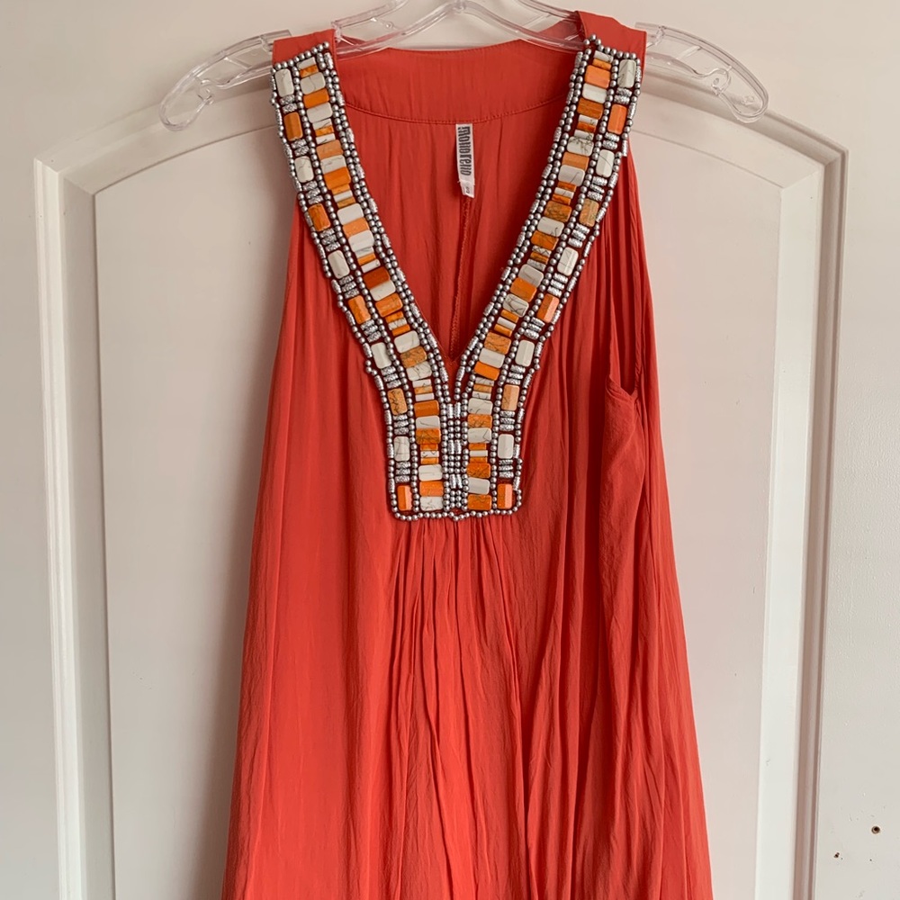 Orange sleeveless dress with beading.